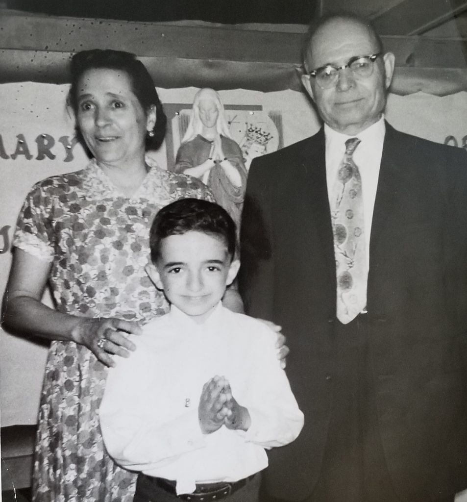 John with his parents. First Communion.